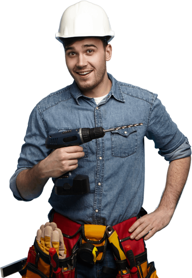 Smiling worker in denim shirt holding drill.